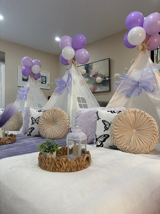 Pastel balloon toppers above sleepover tents