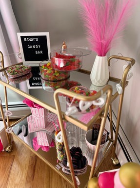 Styled gold bar cart with glassware