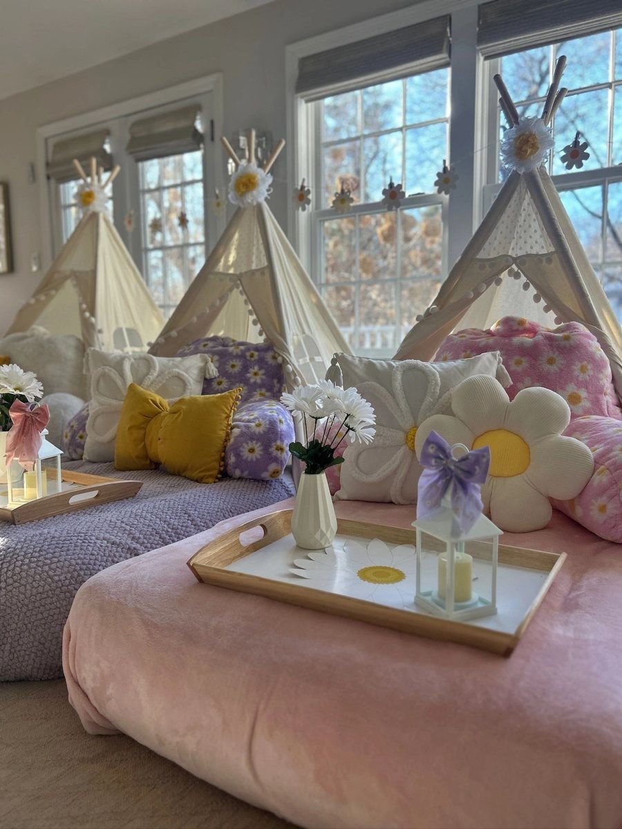 Daisy-themed tent sleepover with pink and purple bedding