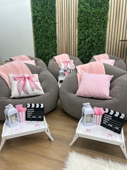Glamping lounge chair setup with pillows and decorated trays