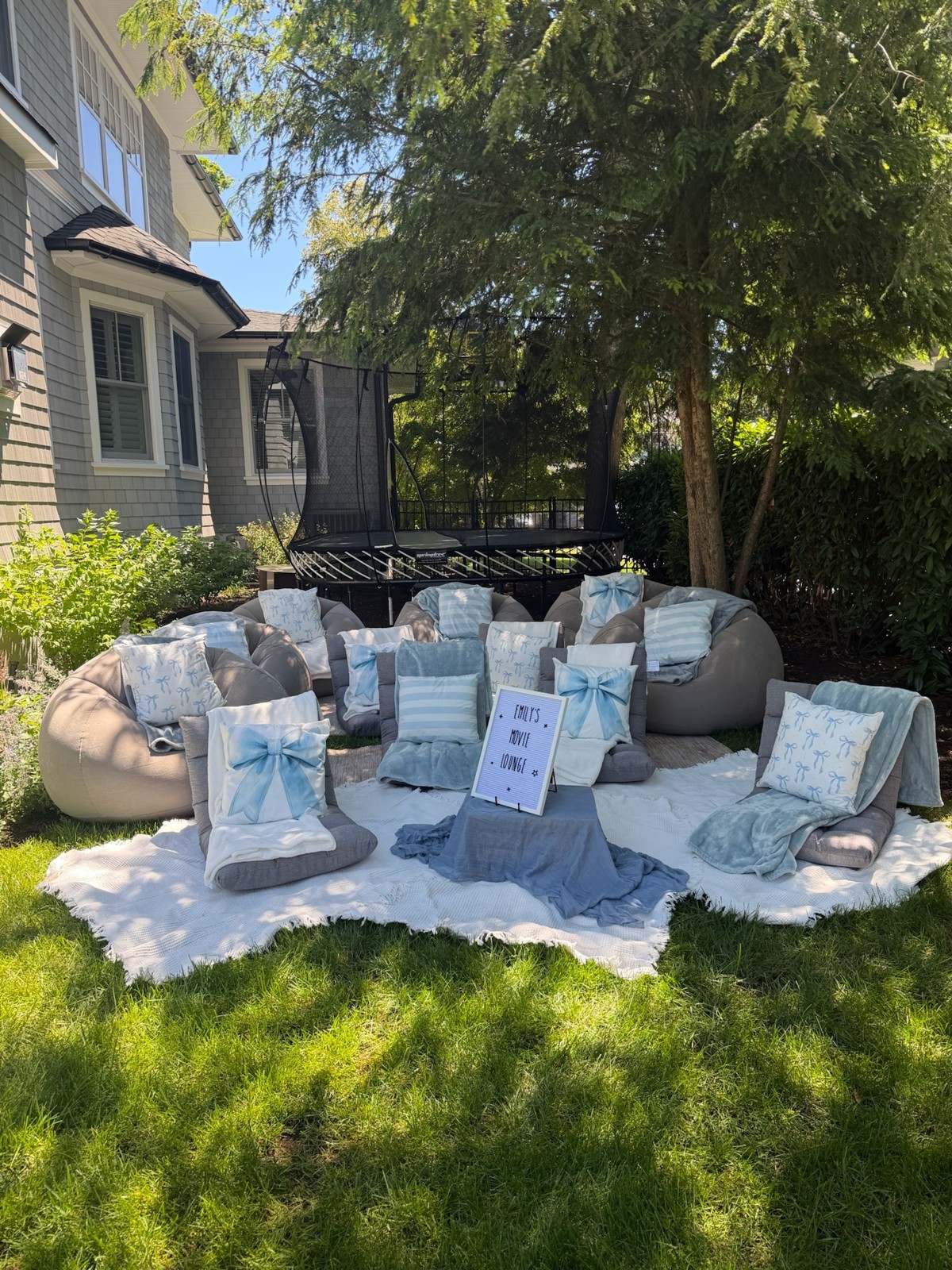 Outdoor lounge chairs styled with blue bows, cushions and individual trays