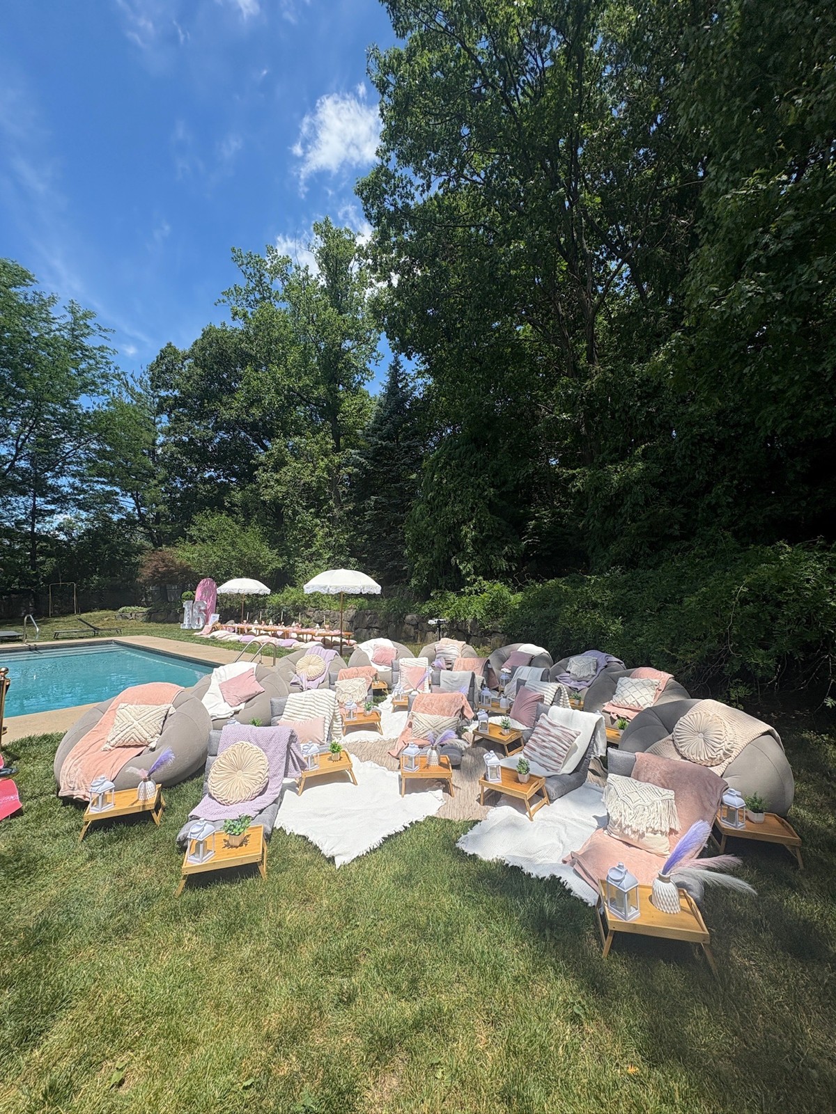 Poolside lounge chairs with pastel cushions and individual party trays