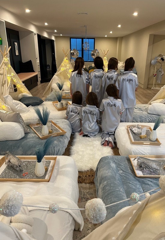 Guests wearing personalized white pajamas and robes