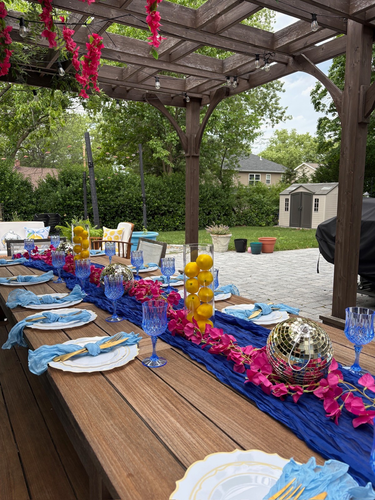 Colorful blue picnic table with pink flowers, yellow accents and a disco ball