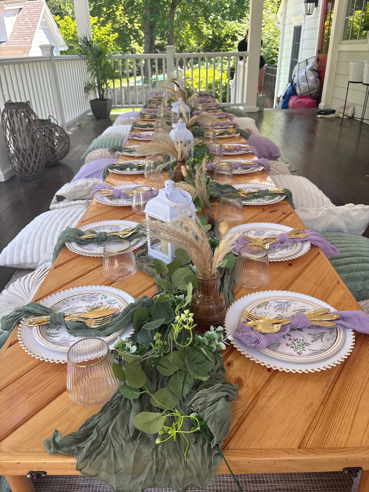 Purple and green picnic table with floral place settings and cushions