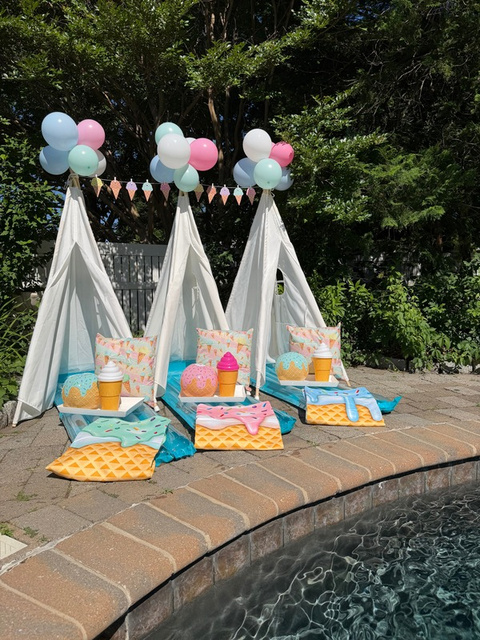 Colorful poolside tents and floats