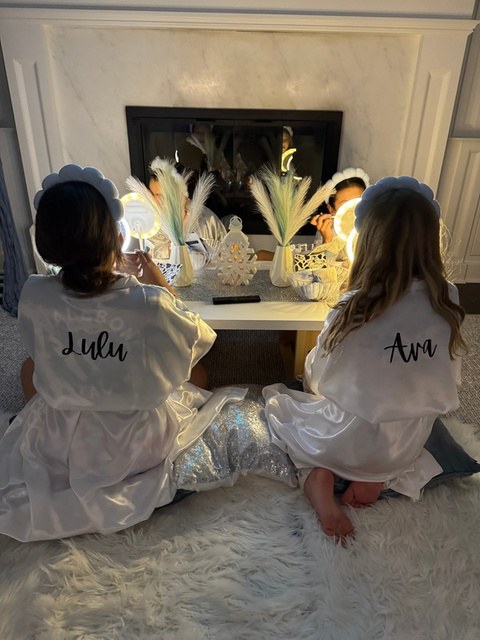 Guests enjoying a spa party with lighted vanity mirrors