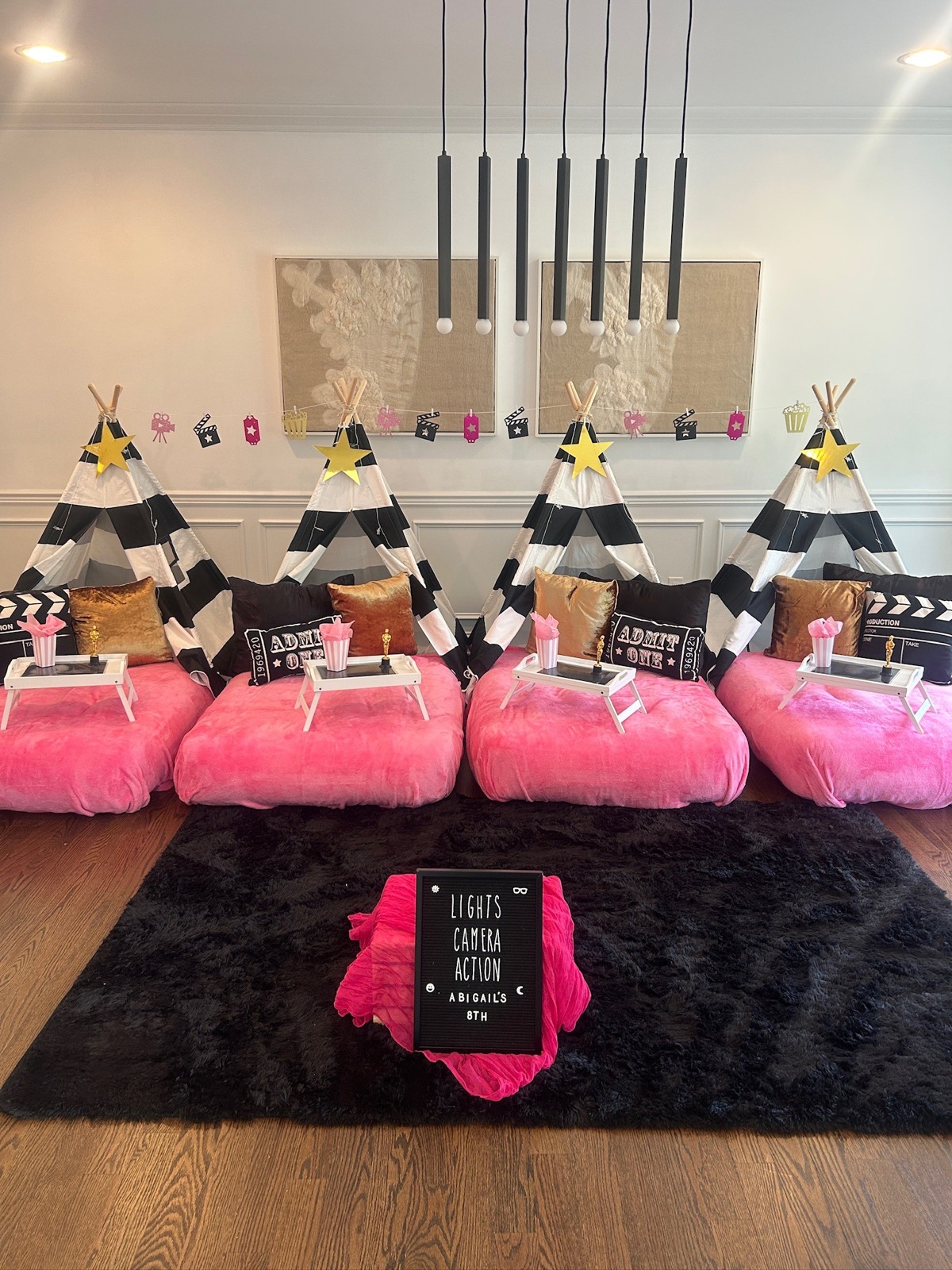 Movie-night tent sleepover with striped tents and pink bedding