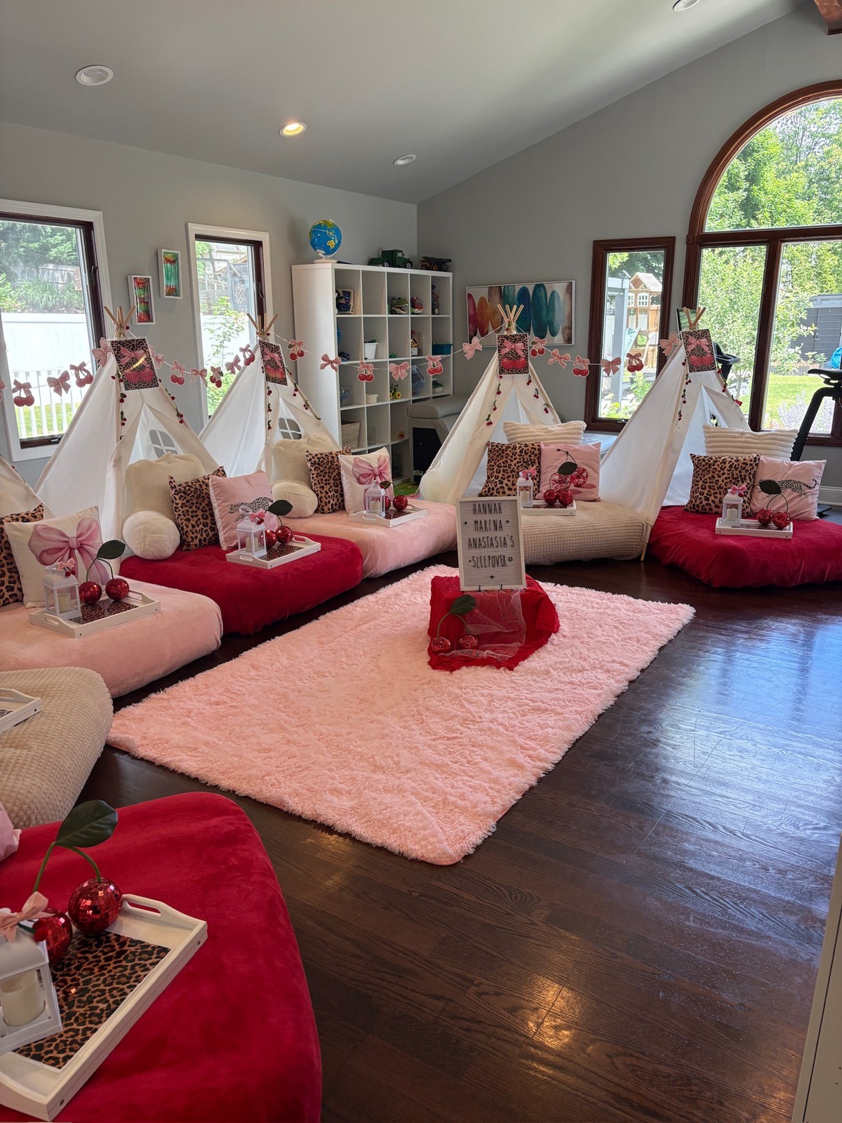 Pink and red tent sleepover with themed pillows and decor