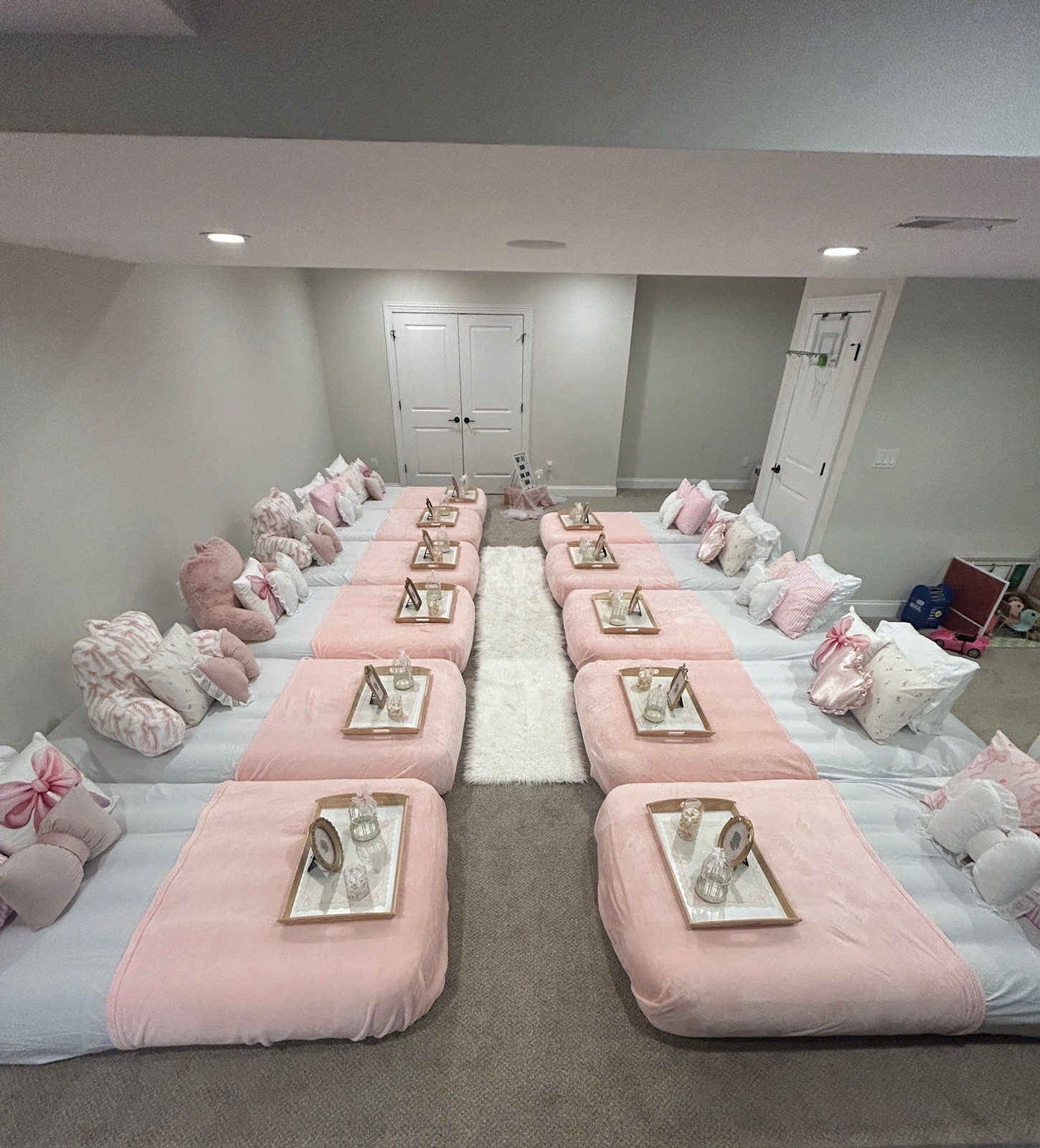 Tentless party with pink mattresses arranged in two rows